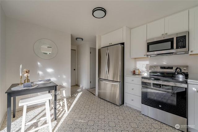 kitchen with white cabinetry and appliances with stainless steel finishes