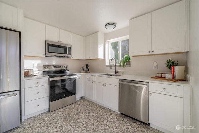 kitchen with sink, white cabinets, and appliances with stainless steel finishes