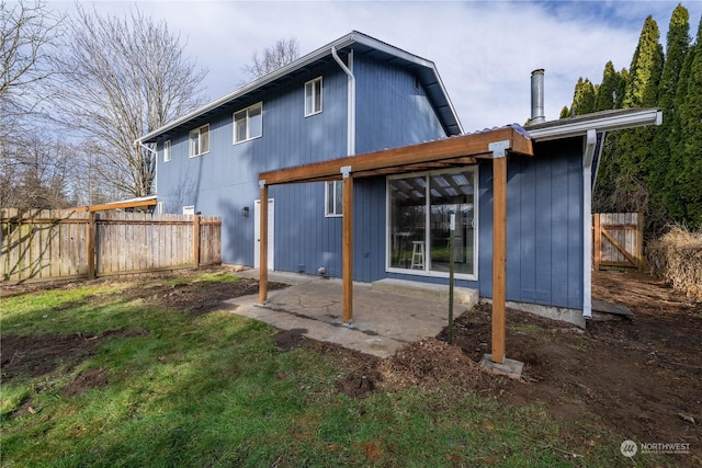 rear view of house with a patio area and a lawn