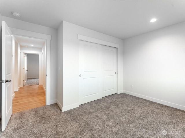 unfurnished bedroom with a closet and carpet flooring