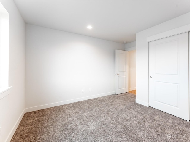 unfurnished bedroom with carpet flooring and a closet