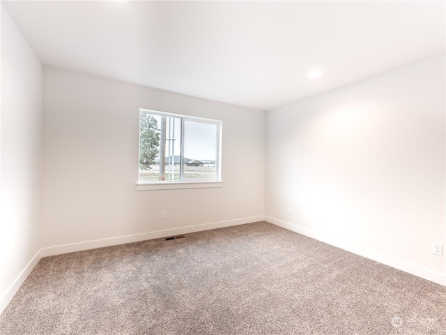 unfurnished room featuring carpet