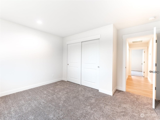 unfurnished bedroom with carpet floors and a closet