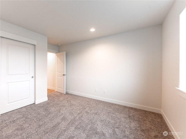 unfurnished bedroom with a closet and carpet flooring