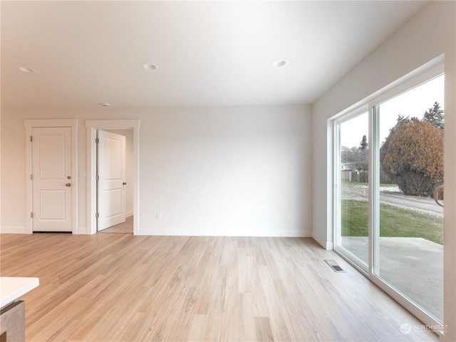 unfurnished room with light wood-type flooring