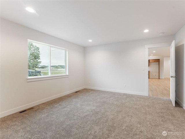 unfurnished room with light colored carpet