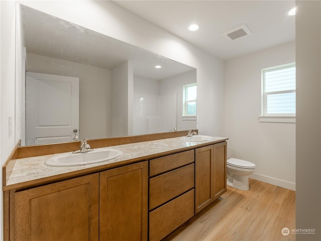 bathroom featuring vanity, hardwood / wood-style floors, and toilet