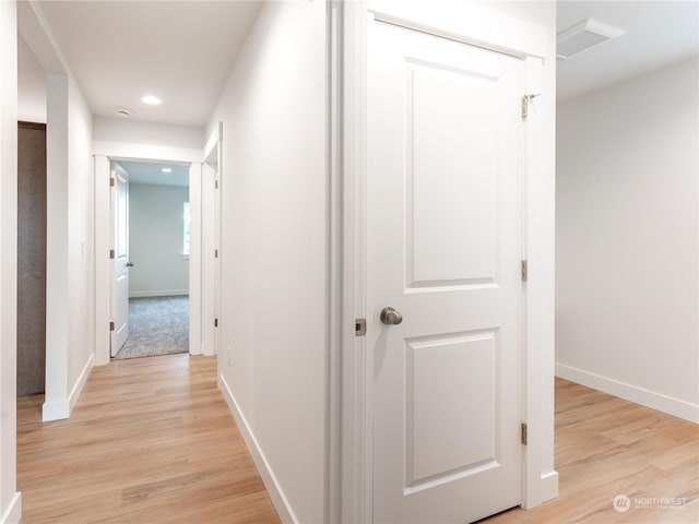 hallway with light hardwood / wood-style floors