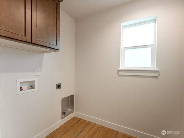 washroom with hookup for a washing machine, light hardwood / wood-style flooring, cabinets, and hookup for an electric dryer