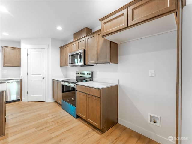 kitchen featuring appliances with stainless steel finishes and light hardwood / wood-style floors