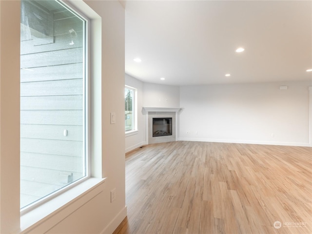 unfurnished living room with light wood-type flooring