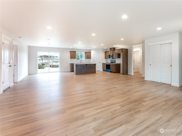 unfurnished living room featuring light wood-type flooring