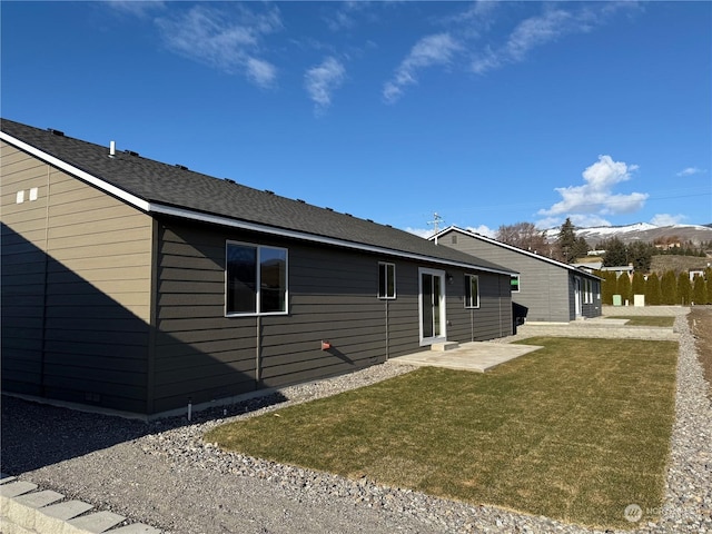 view of property exterior with a lawn and a patio