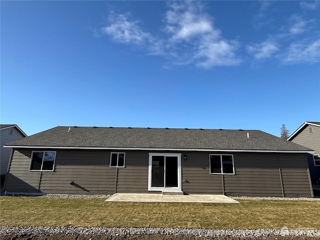 rear view of property with a yard and a patio area