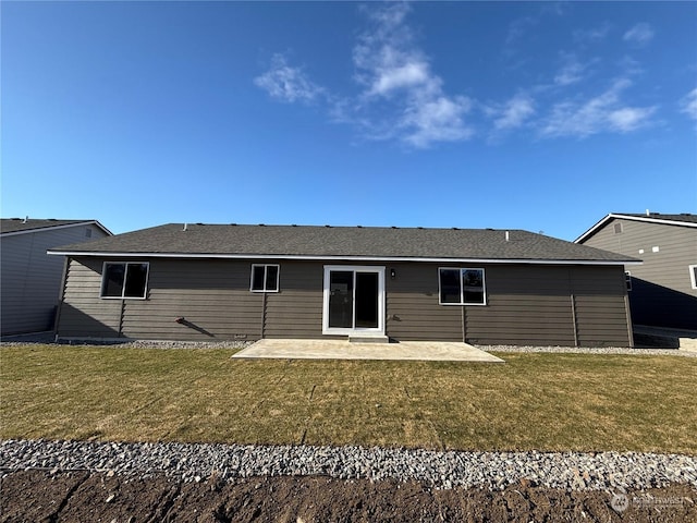 rear view of property featuring a lawn and a patio area