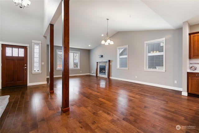 interior space with vaulted ceiling, dark hardwood / wood-style floors, and an inviting chandelier