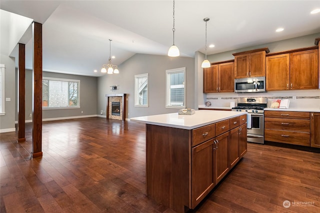 kitchen featuring lofted ceiling, a center island, dark hardwood / wood-style flooring, pendant lighting, and stainless steel appliances