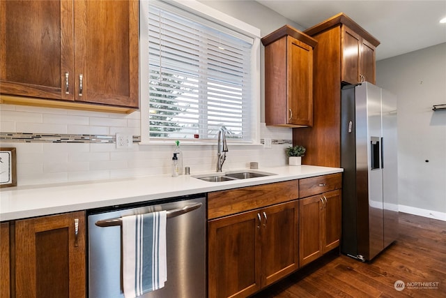 kitchen with sink, decorative backsplash, dark hardwood / wood-style floors, and appliances with stainless steel finishes