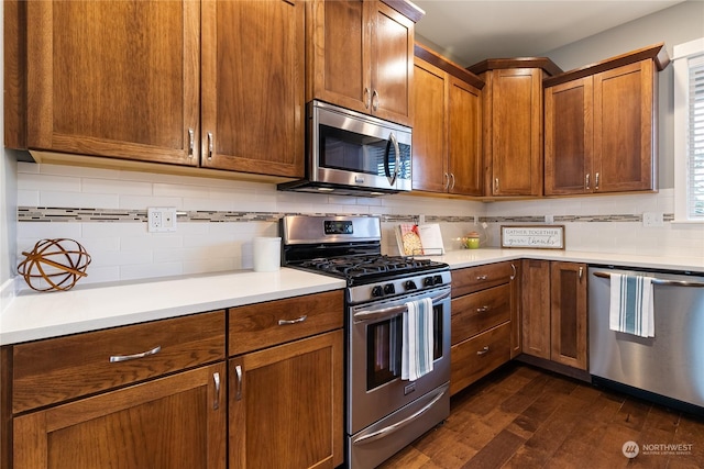 kitchen featuring dark hardwood / wood-style flooring, backsplash, and stainless steel appliances