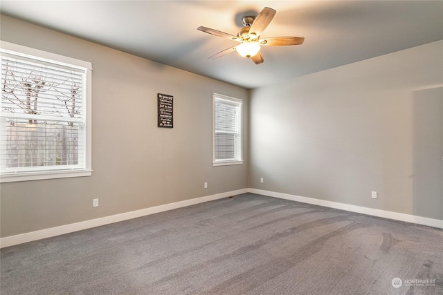 unfurnished room with ceiling fan and carpet flooring