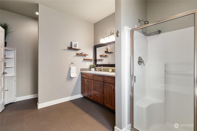 bathroom with tile patterned flooring, vanity, and a shower with shower door