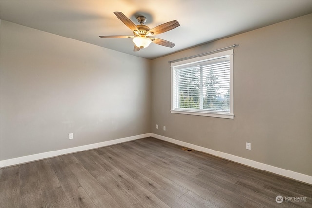 empty room featuring ceiling fan and hardwood / wood-style floors