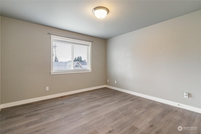 unfurnished room with light hardwood / wood-style flooring