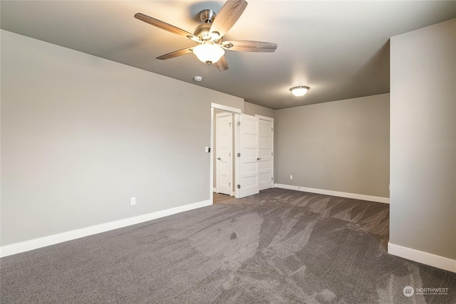 unfurnished bedroom featuring dark colored carpet and ceiling fan