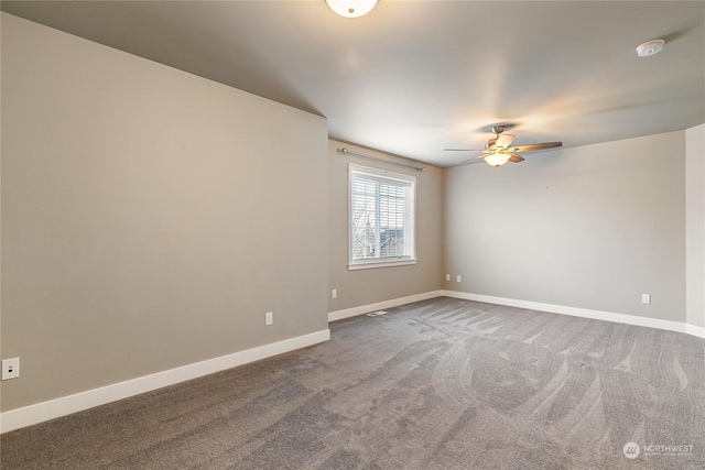 empty room with ceiling fan and carpet flooring