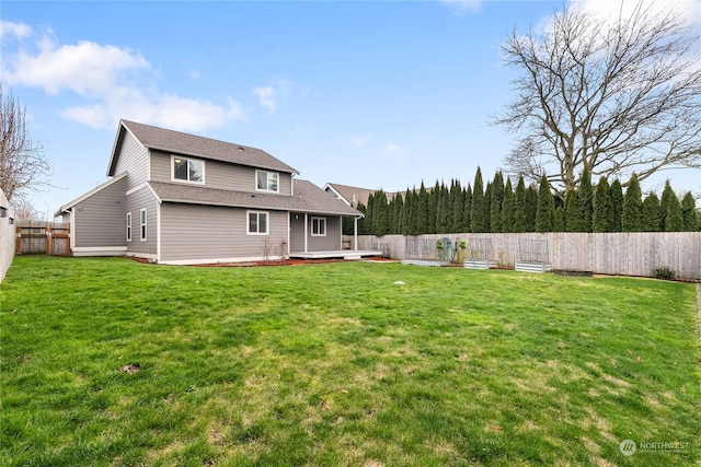 rear view of house with a yard