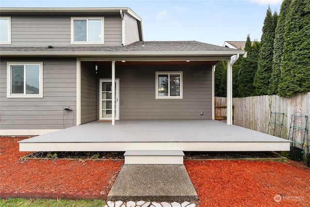 rear view of property featuring a deck