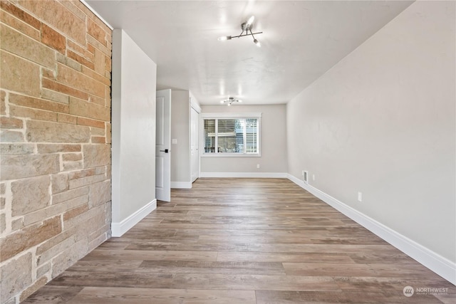 unfurnished room with wood-type flooring