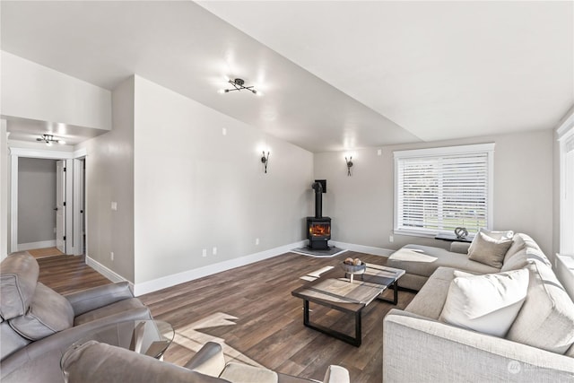 living room featuring dark hardwood / wood-style flooring and a wood stove