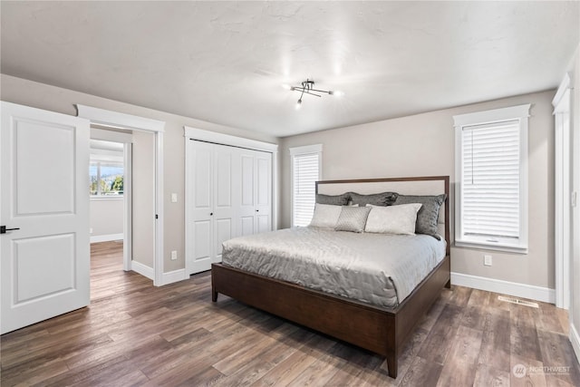 bedroom featuring dark hardwood / wood-style floors and a closet