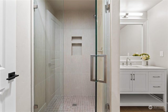 bathroom with walk in shower and vanity