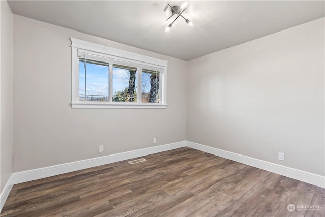 spare room featuring dark hardwood / wood-style flooring