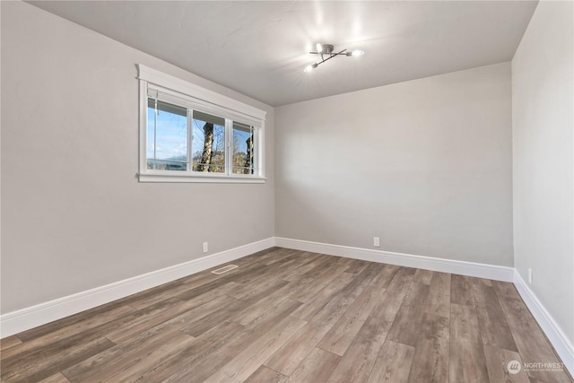 spare room with wood-type flooring