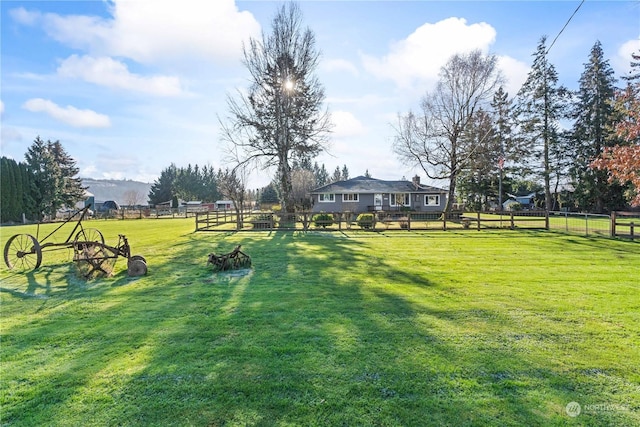 view of yard featuring a rural view and fence