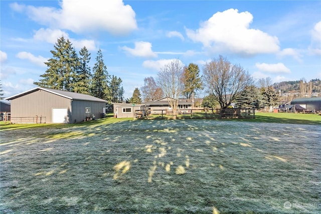 view of yard with a garage and an outdoor structure