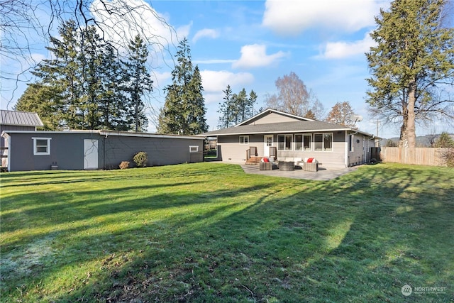 rear view of property with a lawn and a patio