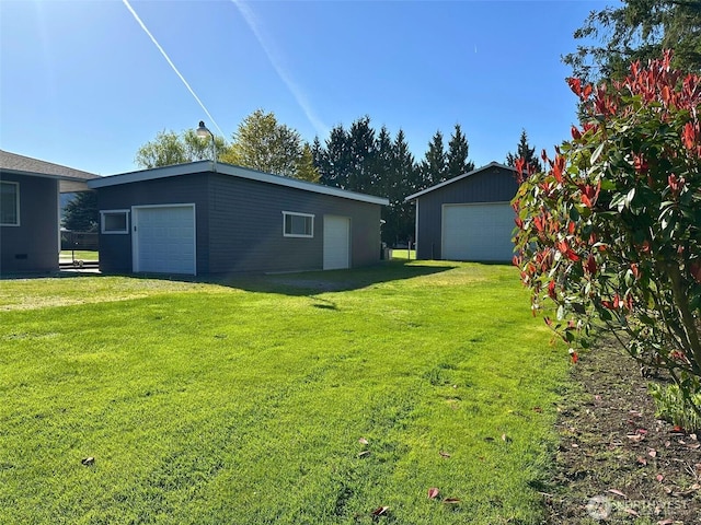 16502 88th St E, Sumner, WA 98390 - view of green lawn featuring a detached garage and an outdoor structure