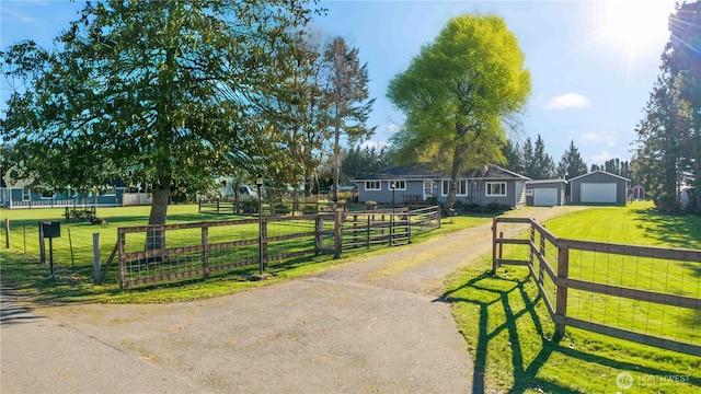 16502 88th St E, Sumner, WA 98390 - view of front of property featuring dirt driveway, a detached garage, and an outdoor structure