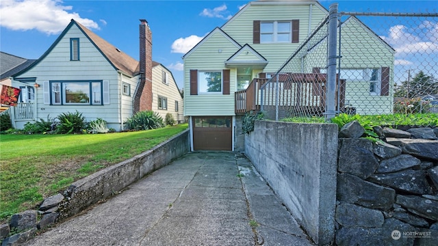 view of front of property featuring a garage and a front lawn