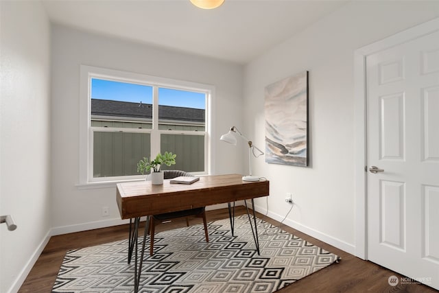 home office with dark hardwood / wood-style flooring