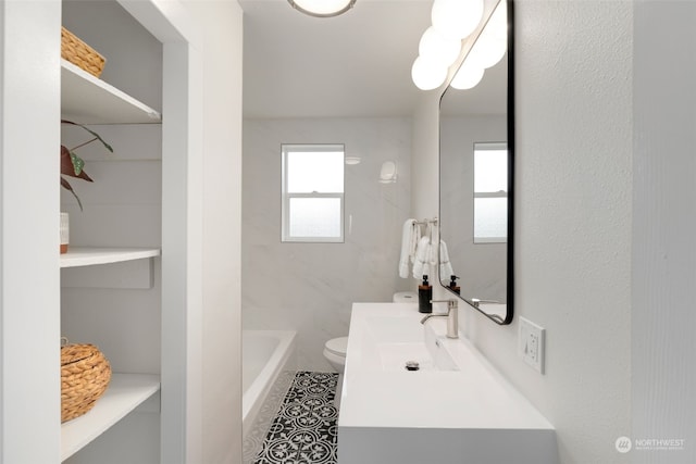 bathroom with tile patterned flooring, vanity, and toilet