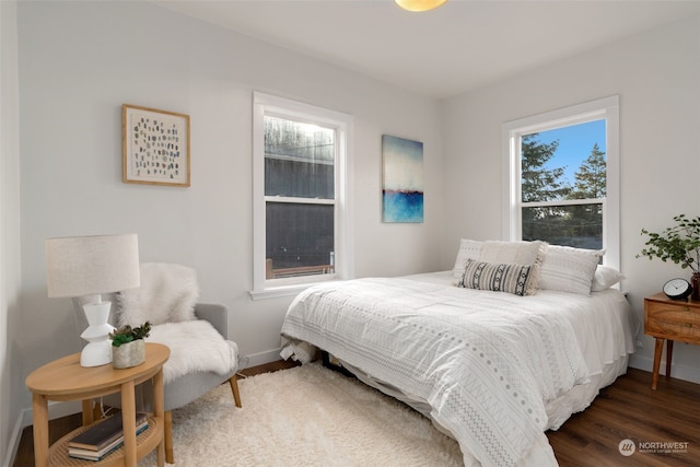 bedroom with dark hardwood / wood-style flooring