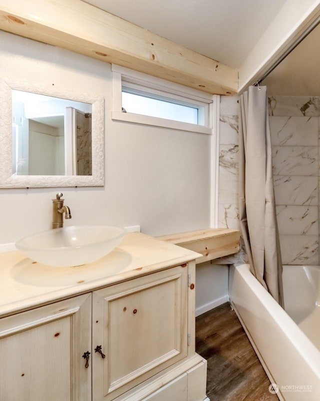 bathroom with wood-type flooring, shower / bath combo, and vanity
