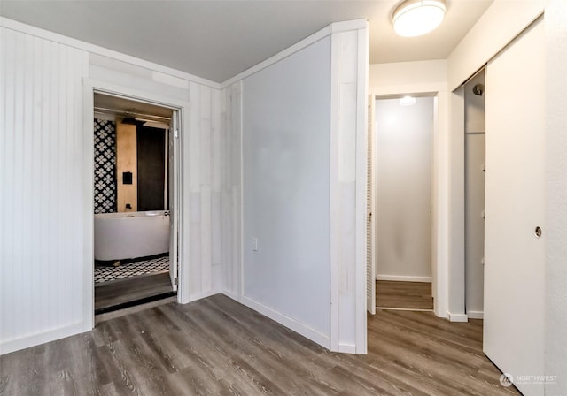 corridor with hardwood / wood-style floors