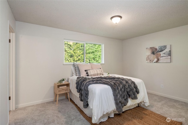 carpeted bedroom with a textured ceiling