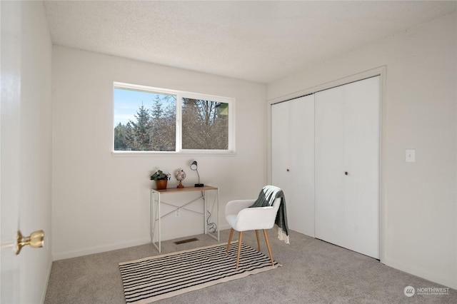 sitting room featuring light colored carpet